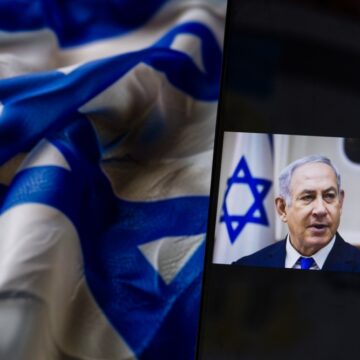 Israeli Prime Minister Benjamin Netanyahu On A Mobile Device With The Israeli Flag In The Background
