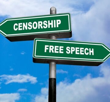 Two Green Direction Signs, One Pointing Left Labeled "Censorship", And The Other Labeled "Free Speech."