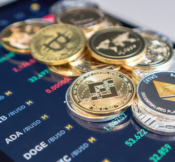 A Selection Of Cryptocurrency Coins Sitting Atop Binance Trading App Screen