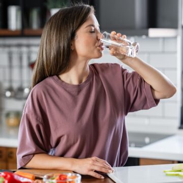 A Healthy Young Woman Drinking A Glass Of Water