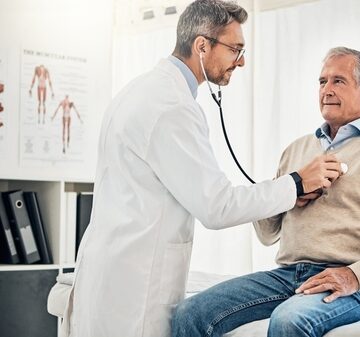 Consultation,,Man,And,Doctor,In,Office,With,Stethoscope,,Checkup,And Older Man Getting Exam By Doctor With Stethoscope