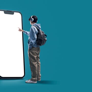 Student With Headphones Interacting With Giant Smartphone With Blank Screen