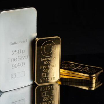 Gold And Silver Bars Of Various Weights On A Black Background