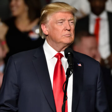 Donald Trump Stands At A Microphone