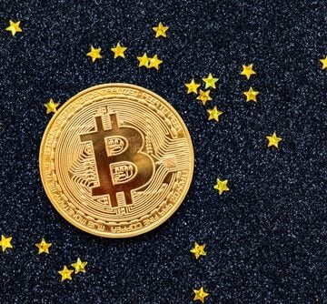 A Bitcoin Against A Starry Background A Bitcoin Against A Starry Background