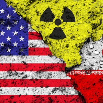 Concept Image Of The U.S. Flag, Iranian Flag, And Nuclear Symbol Painted On Broken Concrete