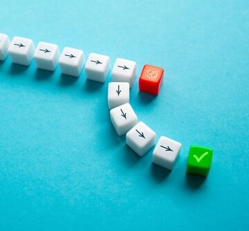 Concept Image Of Cubes With Arrows Moving Around An Obstacle For A New Approach