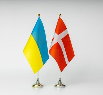 The Flags Of Ukraine And Denmark Side By Side