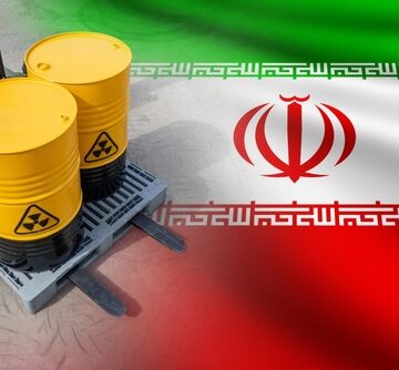 Concept Image Of Barrels With Radioactive Symbols Atop A Flag Of Iran