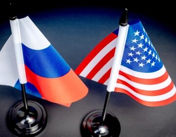 The Flags Of Russia And The United States Side By Side On A Desk