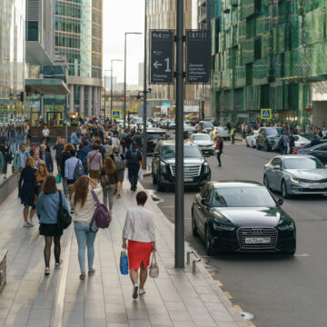 A Bustling Moscow Street With High-end Retail Stores And Offices