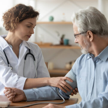 Female Medical Professional Examining Male Patient