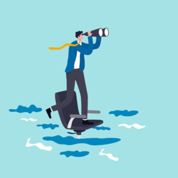 A Businessman Standing On A Sinking Office Chair In Water, Using Binoculars To Look Into The Distance
