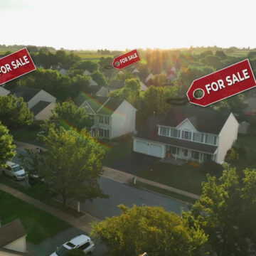 A Suburban Neighborhood With Multiple Houses Featuring Prominent "FOR SALE" Signs A Suburban Neighborhood With Multiple Houses Featuring Prominent "FOR SALE" Signs