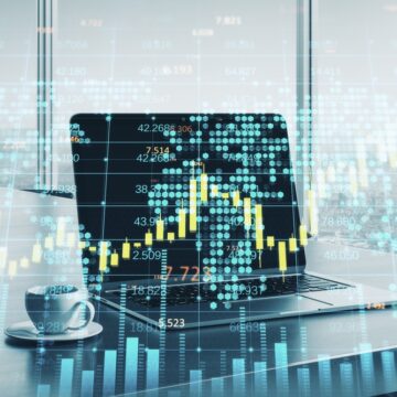 Close Up Of Laptop On A Desktop And A Cup Of Coffee Overlaid With Stock Quotes And Graphs Close Up Of Laptop On A Desktop And A Cup Of Coffee Overlaid With Stock Quotes And Graphs