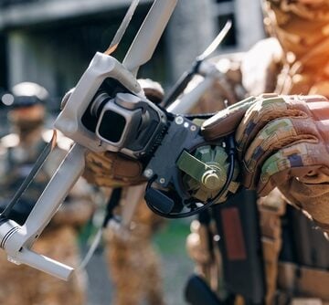 Military Drone Operator With Bomb-Carrying Drone In Hand