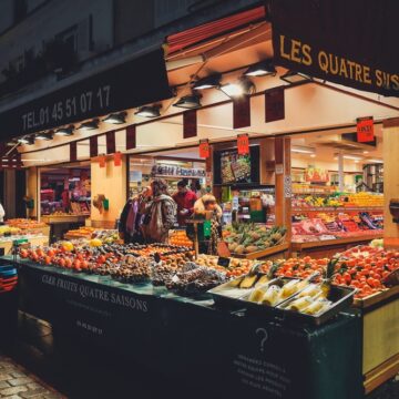 Shoppers Looking At Their Choices At A Produce Market In Paris, France