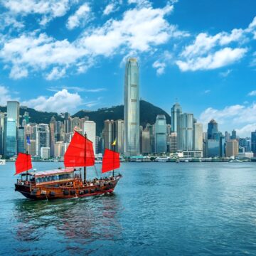 A Scenic View Of A Traditional Junk Boat In Victoria Harbor, Hong Kong City