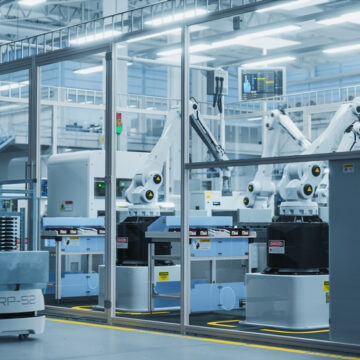 Image Of An Automated Manufacturing Assembly Line Utilizing Industrial Robots And An Autonomous Mobile Robot (AMR)