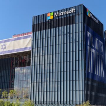 The Exterior Of The Microsoft Development Center building In Herzliya, Israel, With A Large Israeli Flag Displayed On The Facade Of The Building.