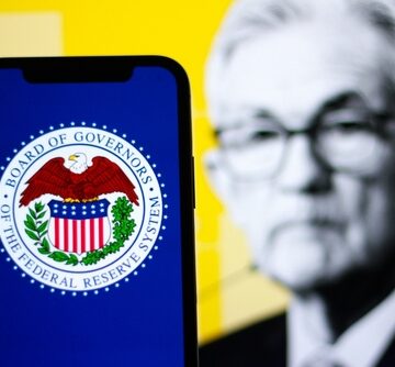 Concept Image Shows The Seal Of The Board Of Governors Of The Federal Reserve System On A Mobile Phone Screen, With Jerome Powell, The Current Chair Of The Federal Reserve, Blurred In The Background