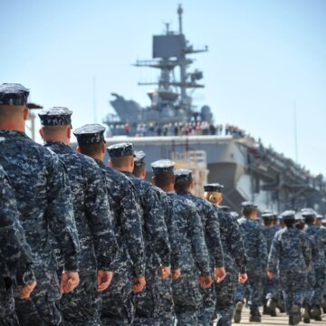 U.S. Sailors And Marines In Formation On An Aircraft Carrier