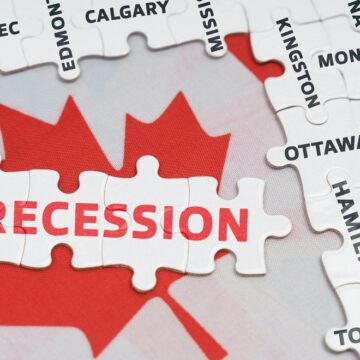 Concept Image Of A Puzzle Map Of Canada With The Word "RECESSION" Written On A Piece Placed Over The Red Maple Leaf In The Center. The Puzzle Pieces Around It Have The Names Of Various Canadian Cities And Provinces