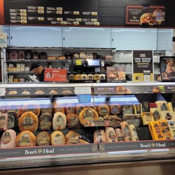 A Boar's Head Deli Counter With Various Meats And Cheeses On Display In New York, NY