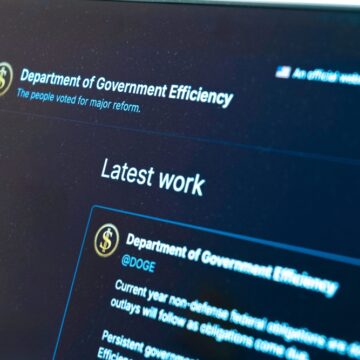 Image Shows A Laptop Screen Displaying A Social media Feed For The "Department of Government Efficiency" (DOGE), With Highlights Of Their "Latest work," Which Includes Updates On Federal Spending And Obligations