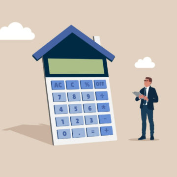 Home Loan Or Mortgage Calculator Concept With A Calculator With A House-Shaped Roof, And A Person Is Standing Next To It, Holding A Tablet And Looking At A Calculator