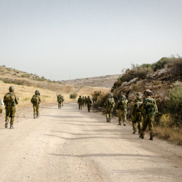 Israeli Combat Soldiers Of An Elite Unit Walking In Formation On A Country Road