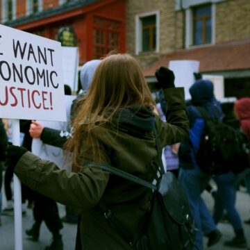 People Participating In A Protest Demanding "Economic Justice"