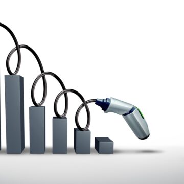 Concept Illustration Of A Downward Bar Chart With An EV Charging Connector And Its Cable Atop The Chart Trend Line