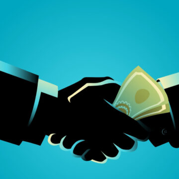 Concept Illustration Of A Handshake, Symbolizing A Deal, With A Banknote Being Passed Between The Hands Suggesting An Illicit Payment