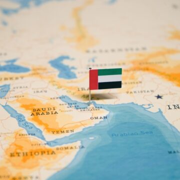 The Image Shows A Map Of The Middle East With A Flag Pin Marking The Location Of The United Arab Emirates (UAE), Located At The Eastern End Of The Arabian Peninsula