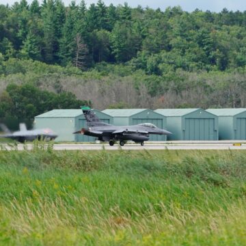 RAF Lakenheath, A Royal Air Force Station In Suffolk, England, Hosts U.S. Air Force (USAF) Units. The Aircraft In The Foreground Is An F-16 Fighting Falcon, And The Aircraft In The Background Appears To Be An F-35A Lightning II