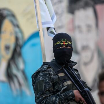A Member of the Palestinian Islamic Jihad In Front Of A Painted Wall