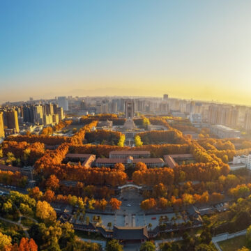 An Aerial Photograph Of The Xi'an Jiaotong University Campus In Xi'an, Shaanxi, China, Showing The University Grounds Surrounded By Modern City Architecture Under A Clear Sky An Aerial Photograph Of The Xi'an Jiaotong University Campus In Xi'an, Shaanxi, China, Showing The University Grounds Surrounded By Modern City Architecture Under A Clear Sky