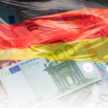 Artistic Composition Featuring The German Flag Draped Over Various Euro Banknotes