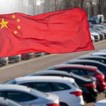 The National Flag Of China Flying Above A Large Inventory Of Vehicles The National Flag Of China Flying Above A Large Inventory Of Vehicles