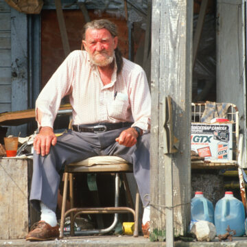 An Elderly Man Sits On His Front Porch In Appalachia, Virginia. This Photo Is Emblematic Of White Working Class, Poverty, And Rural Life