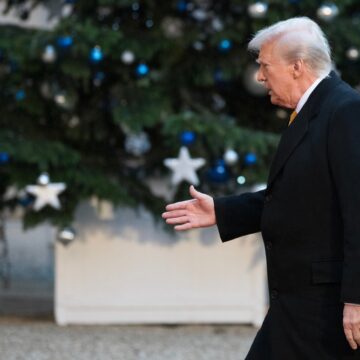 Donald Trump Walking Past A Christmas Tree Decorated With Blue And Silver Ornaments