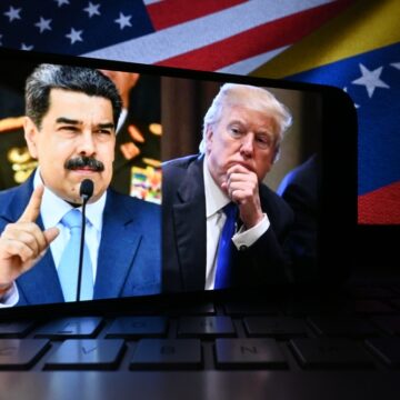 Conceptual Image Of A Smartphone Displaying Images Of U.S. President Donald Trump And Venezuelan President Nicolás Maduro, Set Against The Flags Of Both Nations