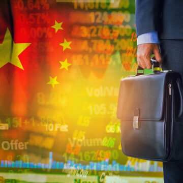 A Businessman Holding A Traditional Black Briefcase, And A Background Composed Of China's Flag And Abstract Financial Data, Including Stock Market Charts And Numerical Data