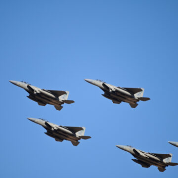 F-15 Eagle Fighter Jets Flying In A Formation Against A Blue Sky