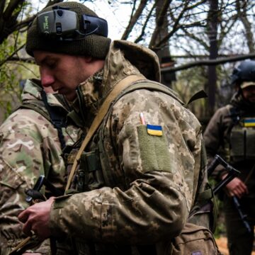 Ukrainian Soldiers Wearing Camouflage Military Uniforms And Gear In A Wooded Environment