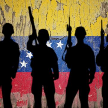 A Silhouette Of Armed Soldiers Against The Venezuelan Flag In The Background