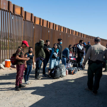Photo Captures A Moment On May 12, 2021, At The U.S.-Mexico Border Near Yuma, Arizona, Where Migrants From Colombia Are Waiting To Be Processed By U.S. Border Patrol Agents After Turning Themselves Over To Authorities