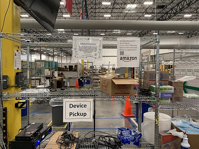 A photo of the interior of an Amazon distribution or fulfillment center, which is a key part of the company's logistics network. A photo of the interior of an Amazon distribution or fulfillment center, which is a key part of the company's logistics network.