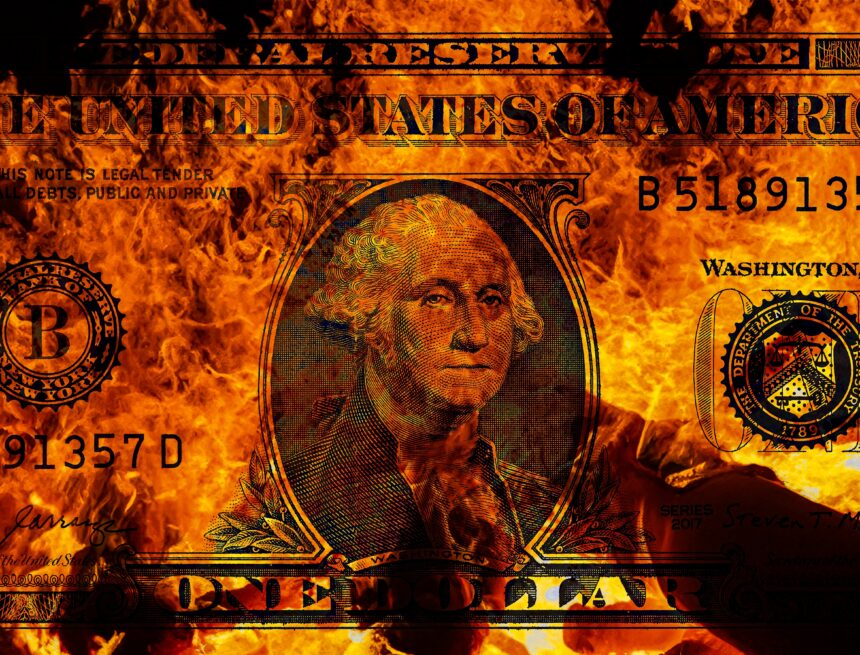 An image of a U.S. one-dollar banknote engulfed in flames.